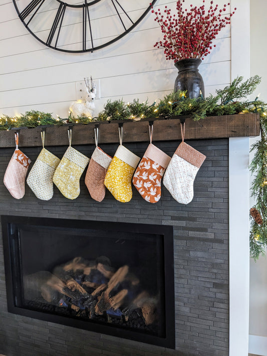 orange Christmas quilted stocking in front of tree