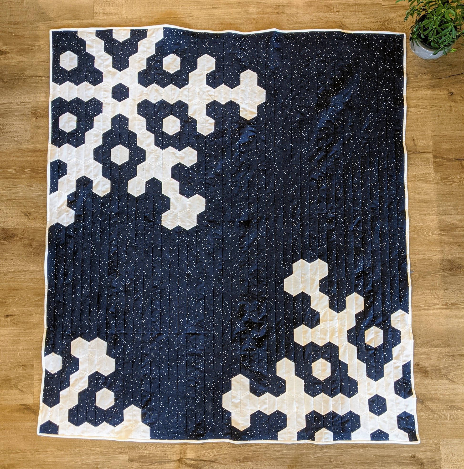 Blue and white snowflake and hexagon quilt on wood.